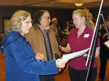 citizens ask questions about a display board at an open house in Lee's Summit